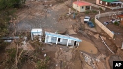 FILE - A house lies in the mud after it was washed away by Hurricane Fiona at Villa Esperanza in Salinas, Puerto Rico, Sept. 21, 2022. Later in the week, a growing number of businesses were temporarily closing across Puerto Rico because of power outages. 