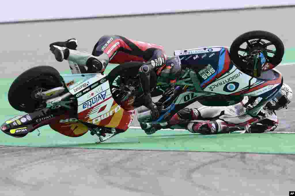 Moto3 riders Nicola Carraro of Italy and Lorenzo Fellon of France, right, crash during the Aragon Motorcycle Grand Prix at the MotorLand Aragon circuit, in Alcaniz, Spain.