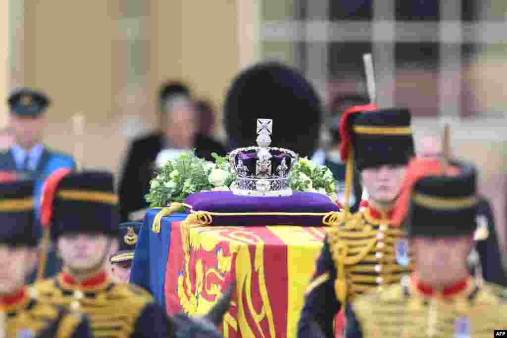 The coffin of Queen Elizabeth II, adorned with a Royal Standard and the Imperial State Crown, is pictured during a procession from Buckingham Palace to Westminster Hall in London, Sept. 14, 2022.