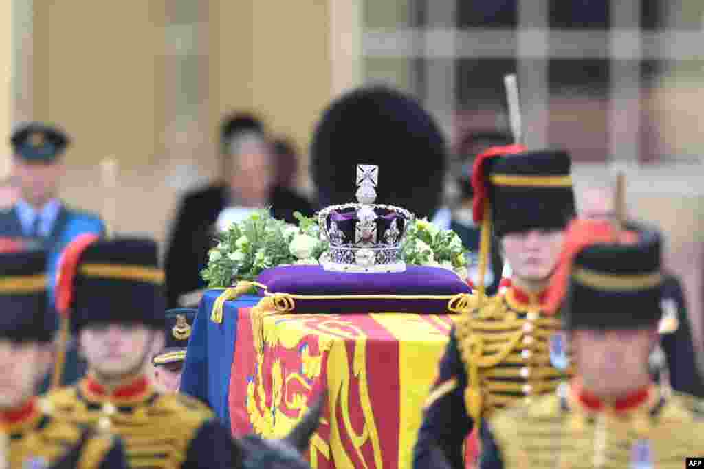 The coffin of Queen Elizabeth II, adorned with a Royal Standard and the Imperial State Crown and pulled by a Gun Carriage of The King&#39;s Troop Royal Horse Artillery, is pictured during a procession from Buckingham Palace to the Palace of Westminster in London, Sept. 14, 2022.