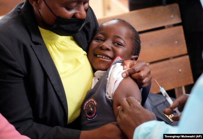 A young girl smiles while been vaccinated against measles at a clinic in Harare, Zimbabwe, Thursday, Sept. 15, 2022. (AP Photo/Tsvangirayi Mukwazhi)