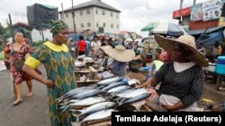 NIGERIA - INFLATION- A customer speaks with a fish seller at Mile 12 International Food market in Lagos, Nigeria May 13, 2022 during with inflation circulating Nigeria. 