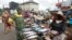 FILE: A customer speaks with a fish seller at Mile 12 International Food market in Lagos, Nigeria. Taken May 13, 2022.