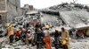 Rescuers take a break at the scene of a collapsed building, blamed on poor construction materials in Kirigiti, Kiambu county, on September 26, 2022.