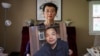 Sophie Luo Shengchun, the wife of jailed Chinese human rights lawyer, Ding Jiaxi, poses with a photo of him at her home in Alfred, New York, July 28, 2022.