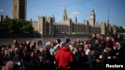 Members of the public line up as they wait to view Queen Elizabeth II's lying in state ahead of her funeral on Monday, in London, Sept. 17, 2022. 