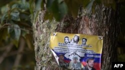 FILE - Picture of a placard of the Revolutionary Armed Forces of Colombia (FARC) dissident guerrilla in Catatumbo, Norte de Santander Department, Colombia, taken on Aug. 20, 2022. 