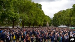 People queue to pay their respects to the late Queen Elizabeth II, outside Westminster Hall in London.