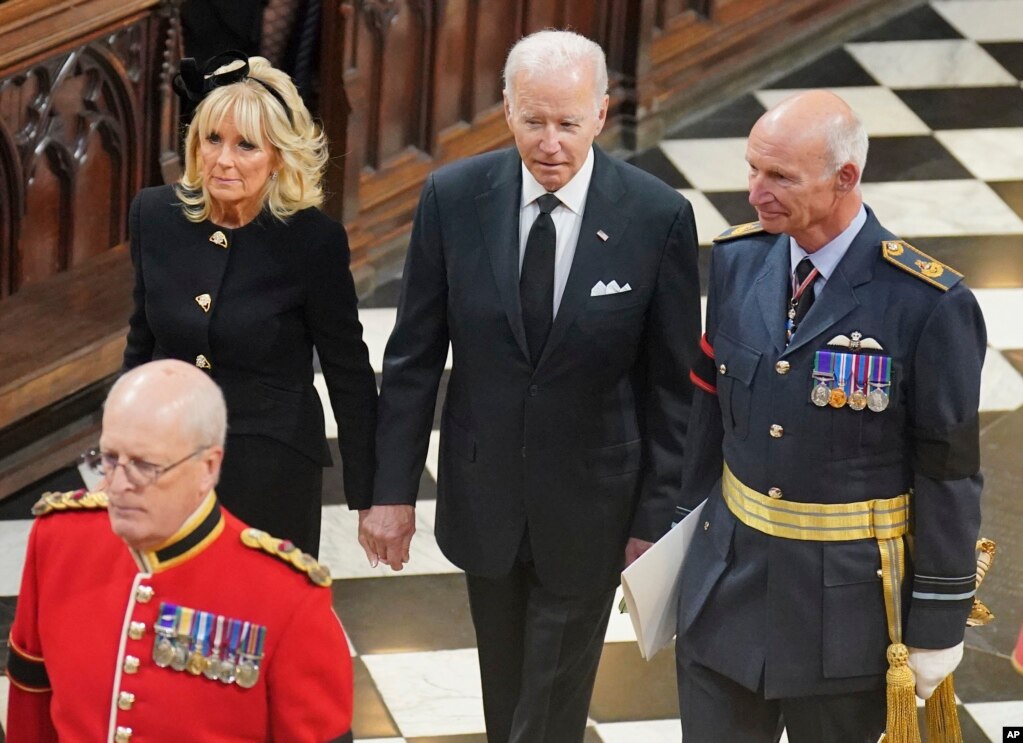 U.S. President Joe Biden, center, and First Lady Jill Biden arrive for the funeral service of Queen Elizabeth II at Westminster Abbey in central London, Sept. 19, 2022. 