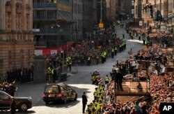 Mobil jenazah yang membawa peti mati Ratu Elizabeth II meninggalkan Katedral St. Giles, di Edinburgh, Skotlandia, Selasa 13 September 2022.