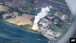 FILE - Steam gushes out of the cooling tower of the Isar 2 nuclear power plant in Essenbach, Germany, Sept.13, 2022.