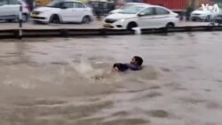 Road Turns Into ‘Swimming Pool’ as Rains Batter India 