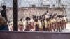 FILE - Pupils stand in line in their school's courtyard in Douala, western Cameroon, on Jan. 13, 2022. Officials in the country say separatist attacks and threats have shut down scores of schools since the school year started on Sept. 5, 2022. 