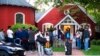 Immigrants gather with their belongings outside St. Andrews Episcopal Church, Sept. 14, 2022, in Edgartown, Mass., on Martha's Vineyard. 