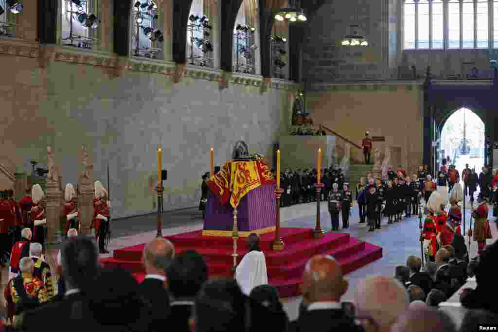 The coffin carrying Queen Elizabeth II is displayed in Westminster Hall, where the queen will be lying in state for four days, Sept. 14, 2022 in London.