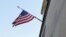 FILE - A U.S. flag flies in front of the Department of Justice building in the U.S. capital of Washington. On Monday, a Canadian man was sentenced to 20 years in prison in the United States for providing assistance to the Islamic State group in Syria. 