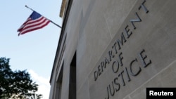 FILE - Signage is seen at the U.S. Department of Justice headquarters in Washington, Aug. 29, 2020. 