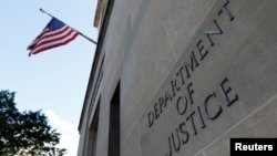 FILE - Signage is seen at the United States Department of Justice headquarters in Washington, Aug. 29, 2020. 