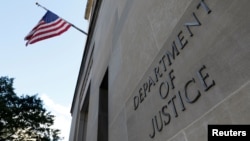 FILE - Signage is seen at the United States Department of Justice headquarters in Washington, Aug. 29, 2020. 