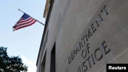 FILE - Signage is seen at the United States Department of Justice headquarters in Washington, Aug. 29, 2020. 