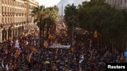 People hold up Esteladas, or Catalan separatist flags, during a demonstration to mark Catalonia's national day 'La Diada' in Barcelona, Spain, Sept. 11, 2022. The banner reads "Independence". 