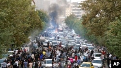 FILE - Protesters chant slogans during a protest over the death of a woman who was detained by the morality police, in downtown Tehran, Iran, Sept. 21, 2022, in this photo taken by an individual not employed by the Associated Press and obtained by the AP 