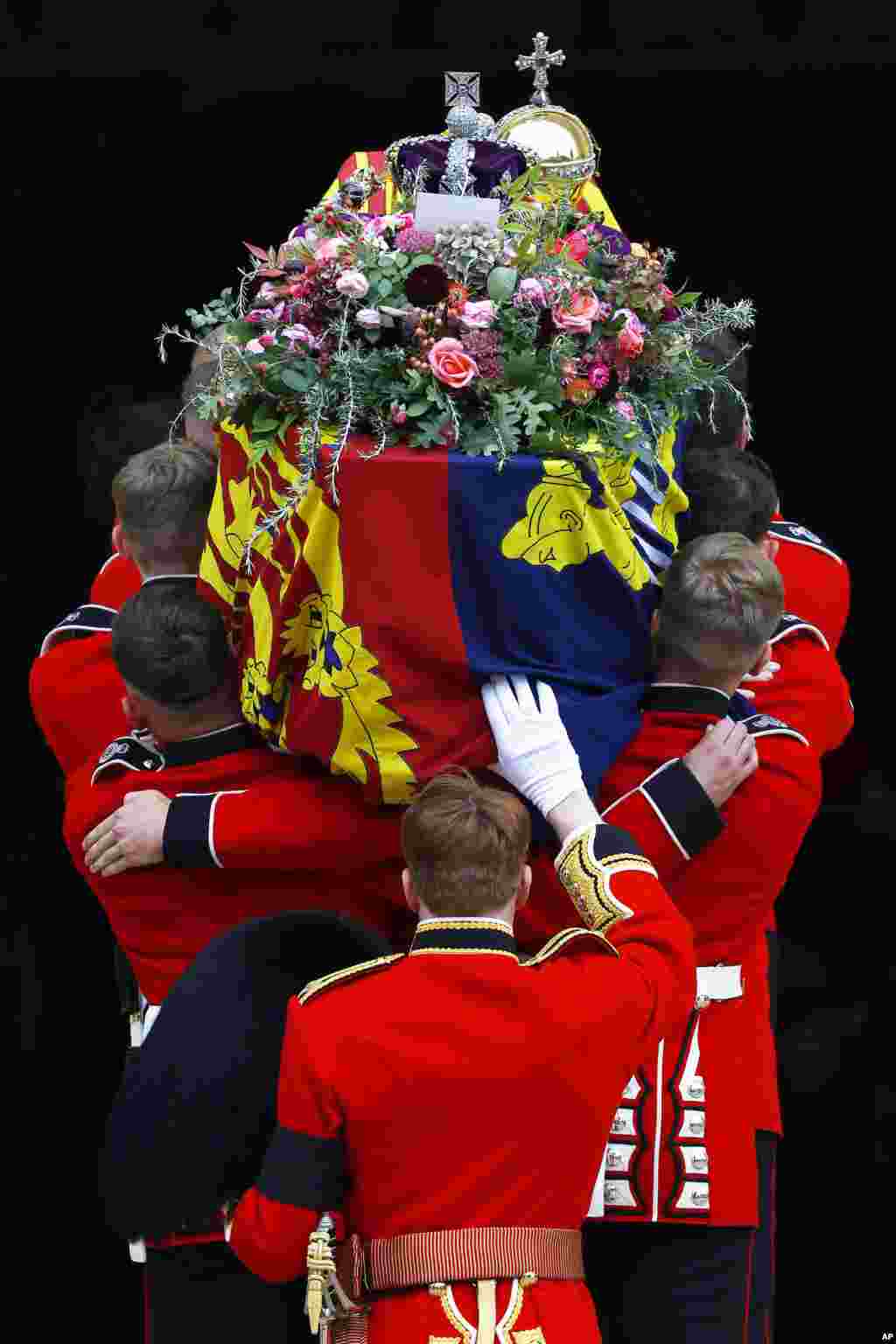 Pall bearers carry the coffin of Queen Elizabeth with the Imperial State Crown resting on top into St. George&#39;s Chapel, in Windsor, Sept. 19, 2022, for the Committal Service for her.