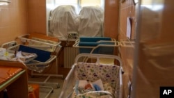 FILE - Veronika, a baby born prematurely at 29 weeks, sleeps in a room fortified with sandbags in the windows at the Pokrovsk Perinatal Hospital in Pokrovsk, Donetsk region, eastern Ukraine, Aug. 15, 2022.