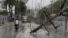 A man on a motorcycle rides past fallen power lines in the aftermath of Hurricane Fiona in Higuey, Dominican Republic, Sept. 19, 2022.