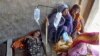 A sick girl and women receive treatment at a temporary medical center setup in an abandoned building, in Jaffarabad, a flood-hit district of Baluchistan province, Pakistan, Sept. 15, 2022. 