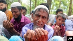 FILE - Rohingya refugees cry while praying during a gathering to mark the fifth anniversary of their exodus from Myanmar to Bangladesh, at a Kutupalong Rohingya refugee camp at Ukhiya in Cox's Bazar district, Bangladesh, Aug. 25, 2022. 