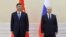 Chinese President Xi Jinping, left, and Russian President Vladimir Putin pose for a photo on the sidelines of the Shanghai Cooperation Organisation summit in Samarkand, Uzbekistan, Sept. 15, 2022. (Sputnik, Kremlin Pool photo via AP)