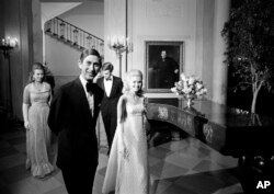 FILE - Prince Charles and Tricia Nixon lead the way to join guests at a White House supper-dance, July 17, 1970.