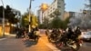 FILE - Police arrive to disperse demonstrators during a protest over the death of Mahsa Amini, a woman who died after being arrested by the Islamic republic's 'morality police', in Tehran, Iran, Sept. 19, 2022.