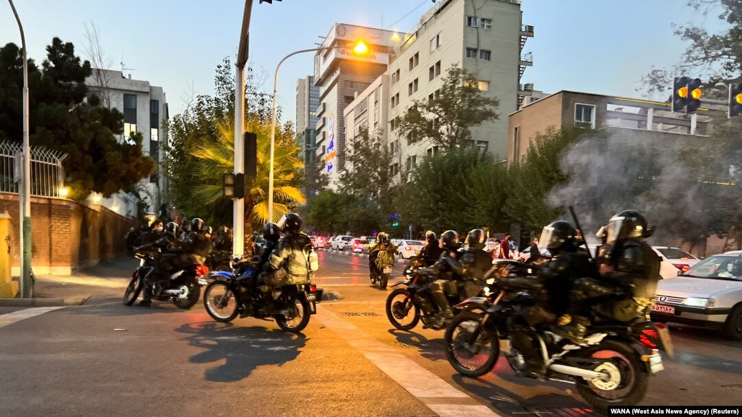 FILE - Police arrive to disperse demonstrators during a protest over the death of Mahsa Amini, a woman who died after being arrested by the Islamic republic's 'morality police', in Tehran, Iran, Sept. 19, 2022.