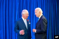 FILE - Britain's Prince Charles, left, greets U.S. President Joe Biden in Glasgow, Scotland, Nov. 2, 2021.