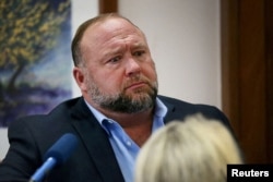 FILE - Alex Jones attempts to answer questions about his emails asked by Mark Bankston, lawyer for Neil Heslin and Scarlett Lewis, during trial at the Travis County Courthouse, Austin, Texas, U.S., Aug. 3, 2022.