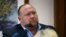 FILE - Alex Jones attempts to answer questions about his emails asked by Mark Bankston, lawyer for Neil Heslin and Scarlett Lewis, during trial at the Travis County Courthouse, Austin, Texas, U.S., Aug. 3, 2022. 