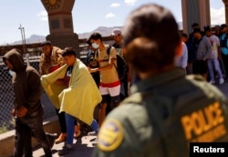 FILE - Migrants, mostly from Venezuela, walk after being detained by U.S. Border Patrol agents after crossing into the United States from Mexico to turn themselves in to request asylum, in El Paso, Texas, Sept. 14, 2022.