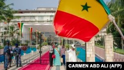 FILE: People take pictures with a Senegalese MP outside the Parliament in Dakar on September 12, 2022 ahead of the first parliamentary session since the July 2022 legislative elections 