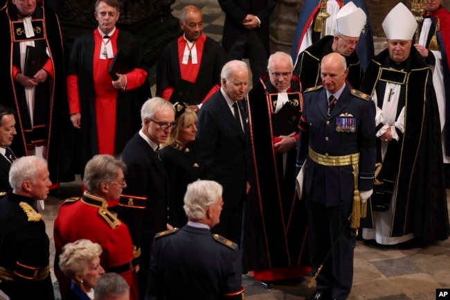 U.S. President Joe Biden and first lady Jill Biden arrive at the Westminster Abbey on the day of Queen Elizabeth II funeral, in London, Sept. 19, 2022. (Phil Noble/Pool Photo via AP)