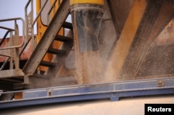 FILE - Vessel Seaeagle unloads wheat from Ukraine on trucks, at Green Harbour, in Port Sudan, Sudan, Sept. 12, 2022.