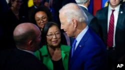 US President Joe Biden speaks with Sen. Chris Coons of Delaware, left, and Sen. Mazie Hirono of Hawaii after speaking at the United We Stand Summit at the White House in Washington, Sept. 15, 2022. 