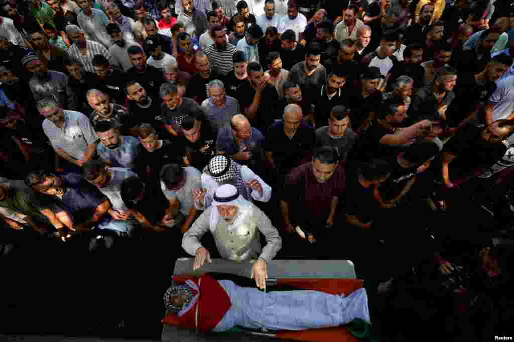 Mourners attend the funeral of Palestinian Udai Tarad, 17, who was killed by Israeli forces during clashes in a raid, in Kafar Dan village near Jenin in the Israeli-occupied West Bank.