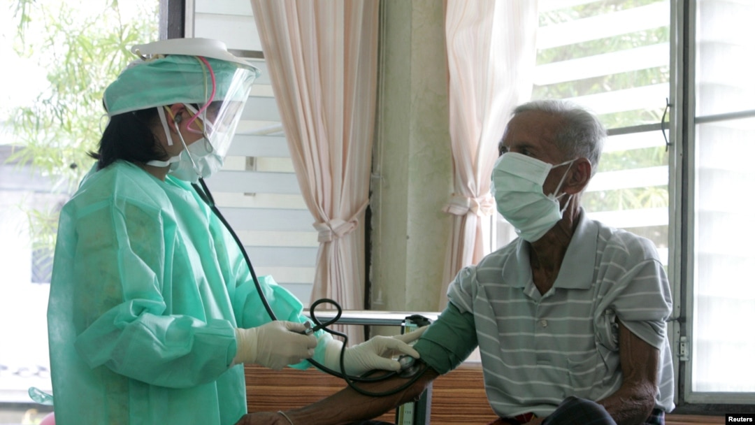FILE - A doctor checks blood pressure during a general check-up on a patient after he claimed that he had a high temperature and fever in a hospital in Khampaengphet province, 310 km (193 miles) north of Bangkok .