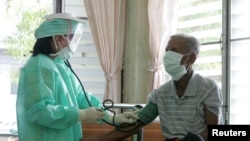 FILE - A doctor checks blood pressure during a general check-up on a patient after he claimed that he had a high temperature and fever in a hospital in Khampaengphet province, 310 km (193 miles) north of Bangkok .