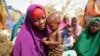 FILE - Nunay Mohamed, 25, who fled the drought-stricken Lower Shabelle area, holds her 1-year old malnourished child at a makeshift camp for the displaced on the outskirts of Mogadishu, Somalia, June 30, 2022. A hunger crisis has grown especially dire in the Horn of Africa.