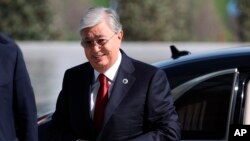 Kazakhstan's President Kassym-Jomart Tokayev, center, arrives to attend the Shanghai Cooperation Organization (SCO) summit in Samarkand, Uzbekistan, Sept. 16, 2022.