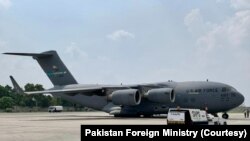 FILE - Pakistan's Foreign Ministry released to media images of a US military aircraft that landed at a military base outside Islamabad on Sept. 9, 2022, bringing relief goods for flood victims.