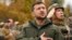 Tổng thống Ukraine Volodymyr Zelenskyy và binh sĩ hát quốc ca, chào cờ khi thăm thành phố Izium, vùng Kharkiv, Ukraine, 14/9/2022. 